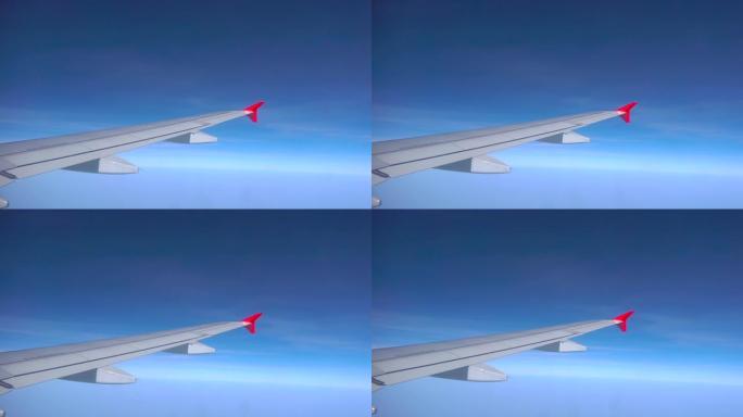 飞机飞行。飞机的翅膀在日落天空的云层上飞行。从飞机的窗户看。飞机，飞机。乘飞机旅行。4K超高清视频