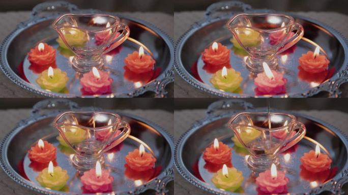 按摩师purs按摩oil in a glass container。Candles are burn