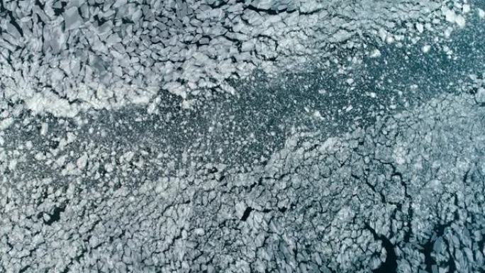 裂开的浮冰的鸟瞰图。全球变暖，气候变化冬季背景
