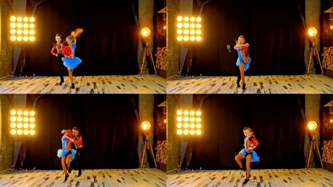 专业运动员跳杂技摇滚、踢和跳。穿着西装的运动员跳舞动作和微笑。