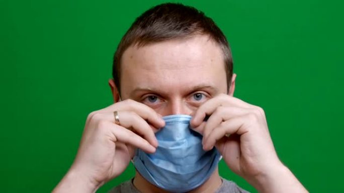 特写。男人戴上防护医用口罩。在疫情病毒的恐慌中。冠状病毒大流行的COVID危险2019-ncov。在