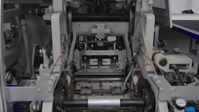 造纸生产线中的工业机器人。经营生产线机器在工作。