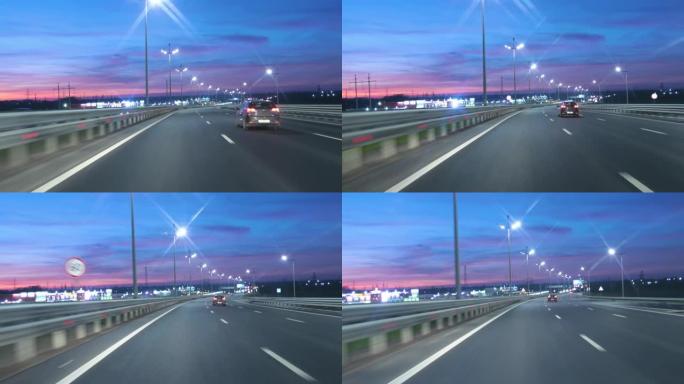 日落之后，晚上在高速公路上开车，交通很少。黄昏日落路灯。晚上，摄像头在前面，挡风玻璃参考。在黑暗的4