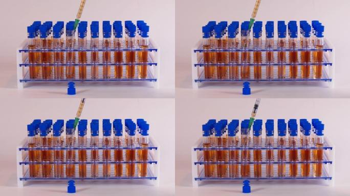 医学实验室用橙色液体试管和针头