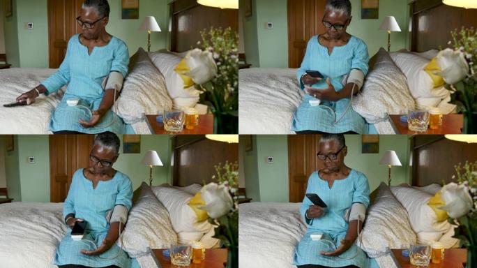 年长的黑人妇女使用智能手机扫描她的血压读数