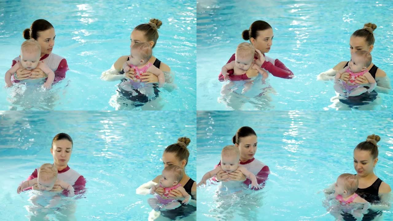 游泳课。母亲在游泳池里教新生婴儿游泳