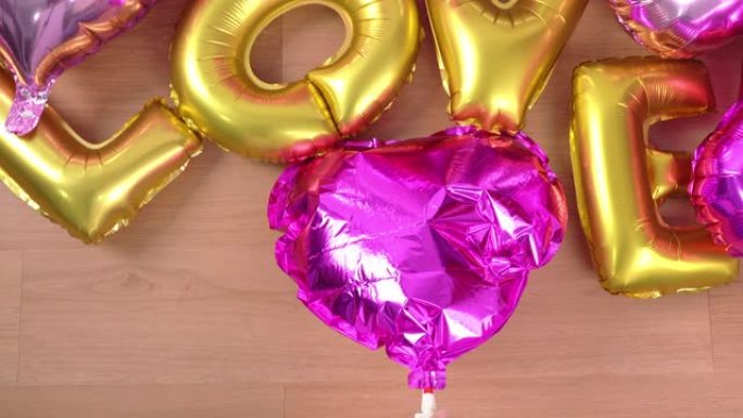 女人是手动抽气，将空气放入形状的气球中，用充气机在家准备节日派对装饰，特写，4K，生活方式。