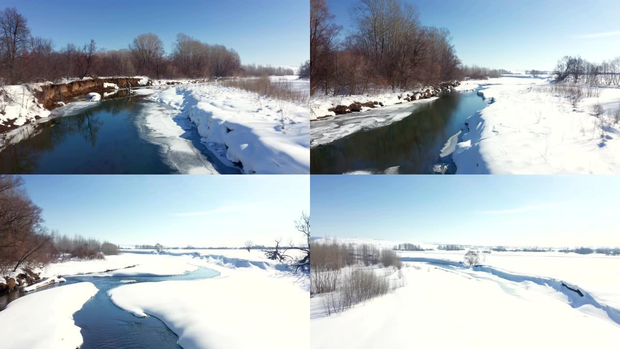 在下雪的冬季晴天，部分结冰的河流拍摄