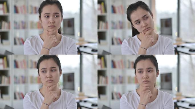 年轻的亚洲女性思考新观念的肖像