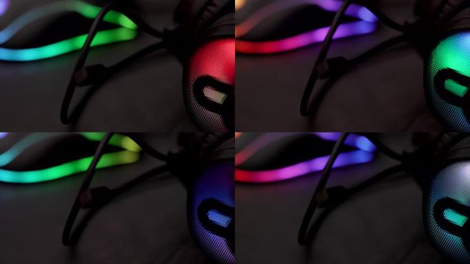 电脑RGB游戏耳机的特写镜头，由彩色发光二极管照明