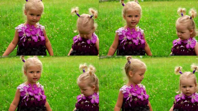 两个穿着紫色幻想连衣裙的小姐妹正在看镜头
