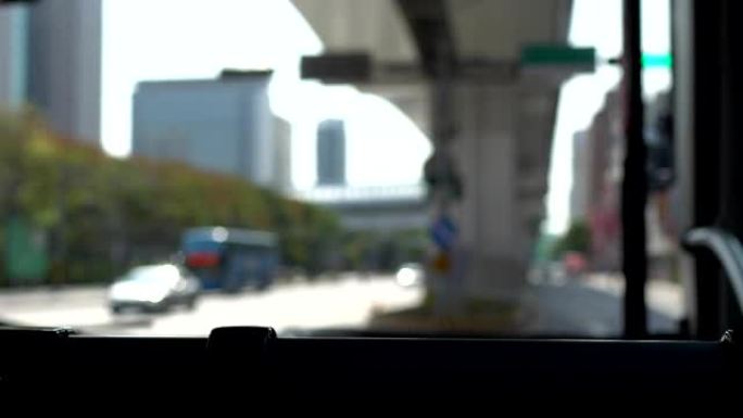 View from Windshield of a bus. Stop at the the red