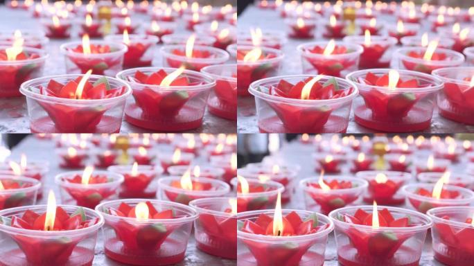 红莲蜡烛留在桌子上。祈求好运。中国新年。中国寺庙。