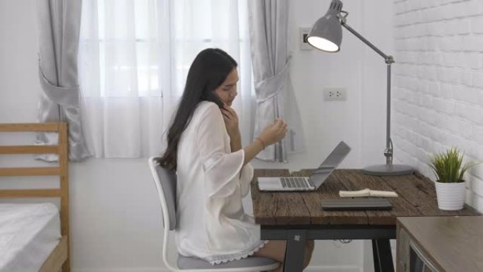 聪明的亚洲年轻企业家商业女性中小企业在线聊天并保存到在家工作的笔记本电脑。