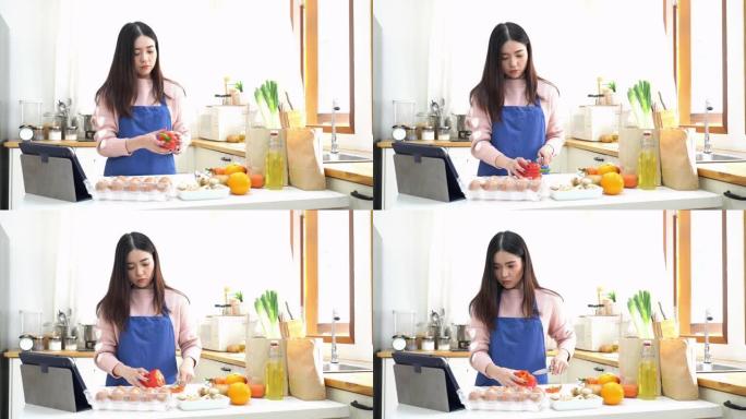 年轻的泰国妇女尝试通过学习社交媒体在周末准备和蔬菜早餐