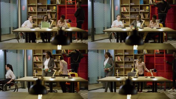 自信的黑人女商人在现代办公室图书馆范围的多莉镜头中向不同的同事提供建议后坐起来