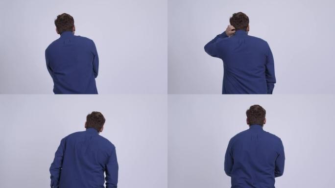 年轻的大胡子印度商人思考和环顾四周的后视图