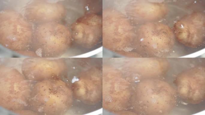 在煮沸的水煮熟土豆的过程。土豆在皮肤里。厨房概念