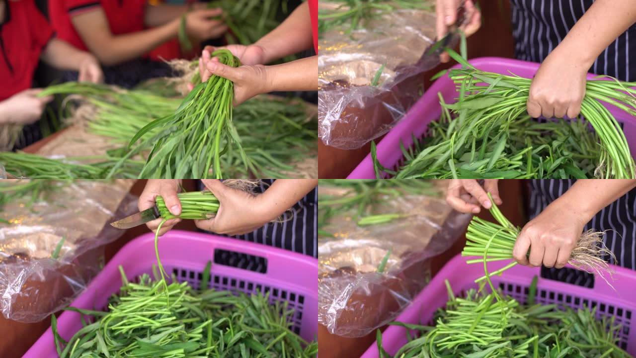 厨师切水牵牛花，油炸中国水牵牛花的原料，泰国流行的街头食品。4k俯视图和手持移动摄像机。