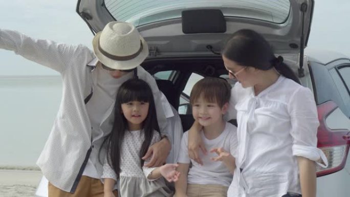 快乐的亚洲家庭坐在车里去海滩旅行，在度假中一起放松身心，享受快乐的父母在夏天以热带度假的概念在海上休