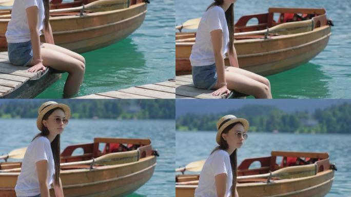 年轻女子在斯洛文尼亚的布莱德湖旁放松