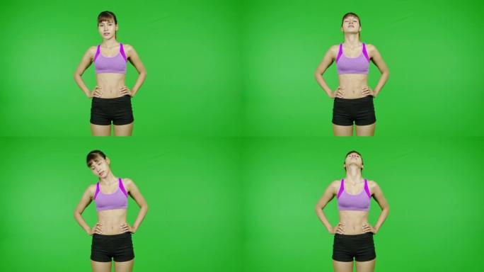 颈部暖身、绿屏、运动、伸展。适合年轻的亚洲运动妇女在紫色的布料做热身运动在镜头前。