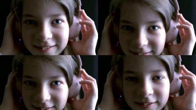 一个十几岁的女孩戴着耳机听音乐。