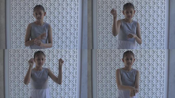 亚洲小女孩的肖像正在快乐地练习唱歌和跳舞。