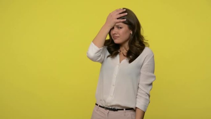 Facepalm. Frustrated woman with brunette hair in b