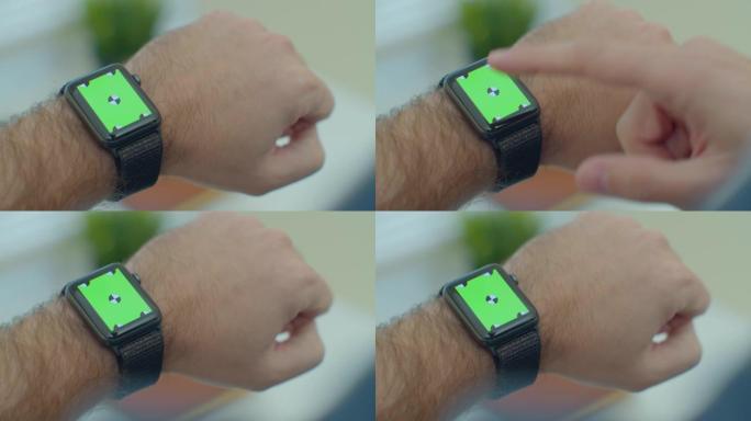 人手使用智能手表与绿屏chromakey内容触摸显示通信特写。