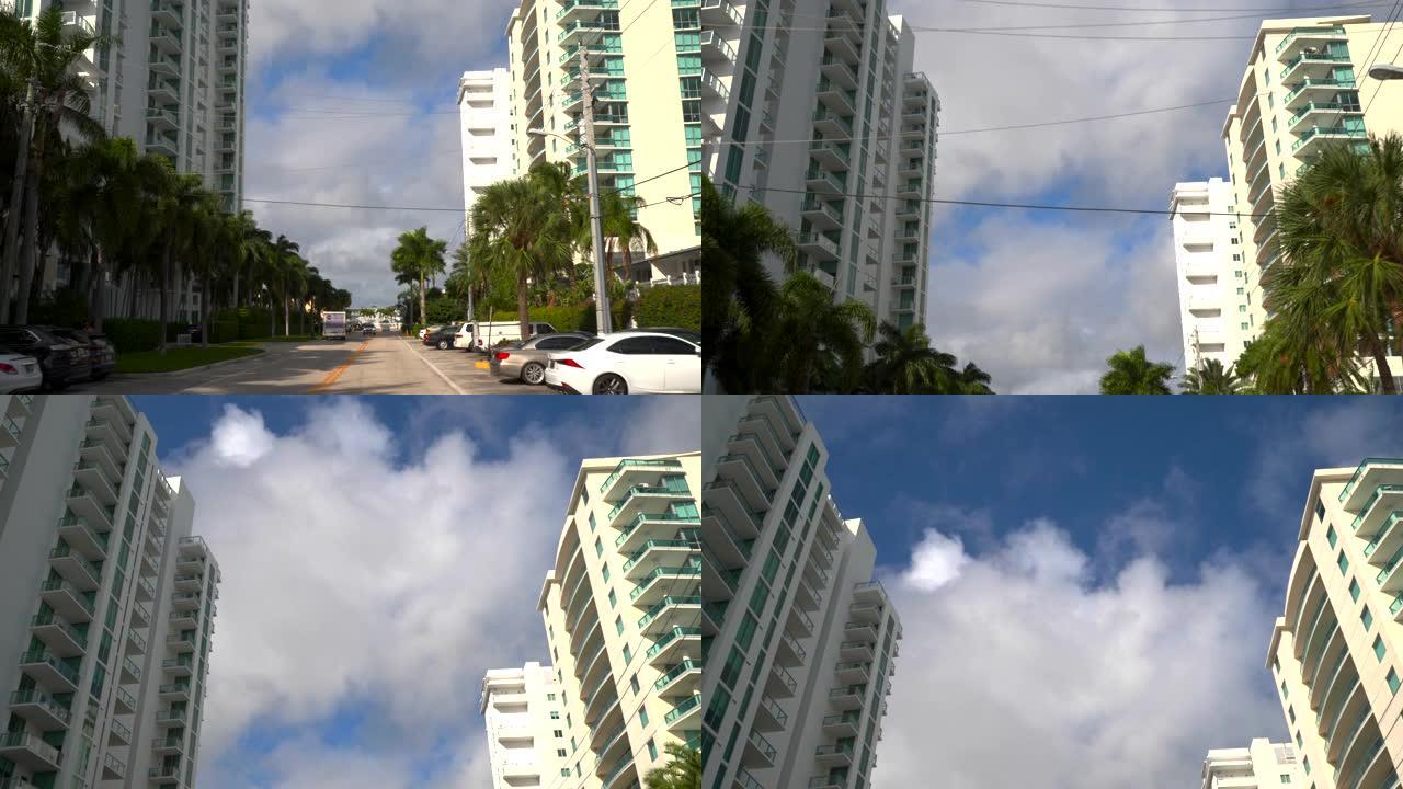 沿着郊区道路行驶摄像头向上倾斜显示公寓建筑物