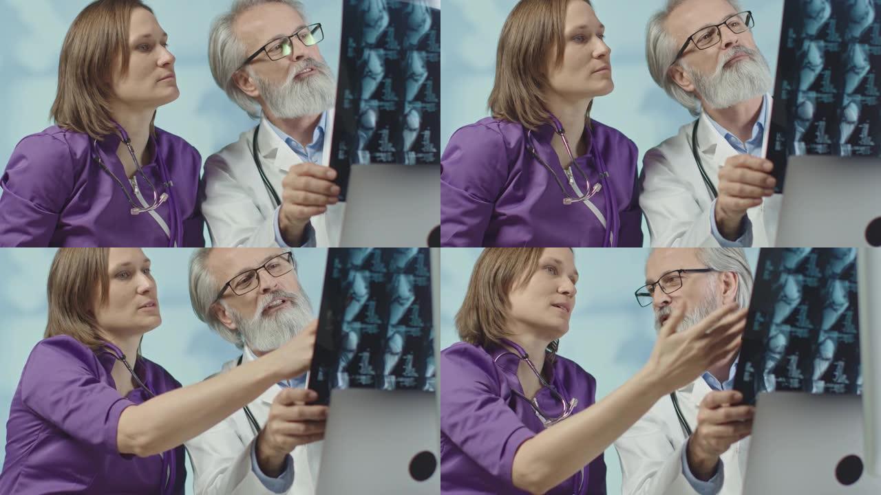 医生和一名护士正在看x光和ct扫描。电晕感染。中拍，4k慢动作