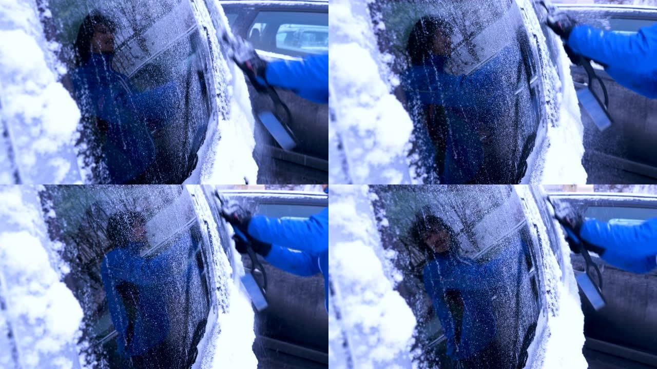 男子用手清洁白雪上的车窗