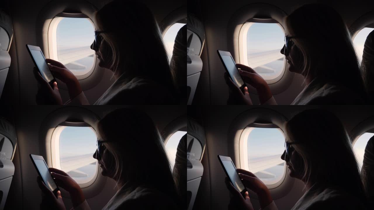年轻女子在飞行中阅读电子书