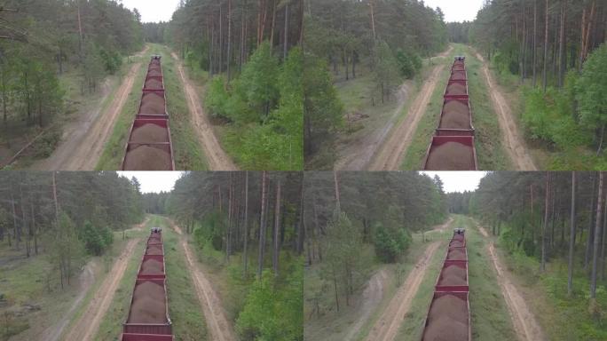 森林背景上窄轨铁路机车的鸟瞰图。泥炭的提取和运输。