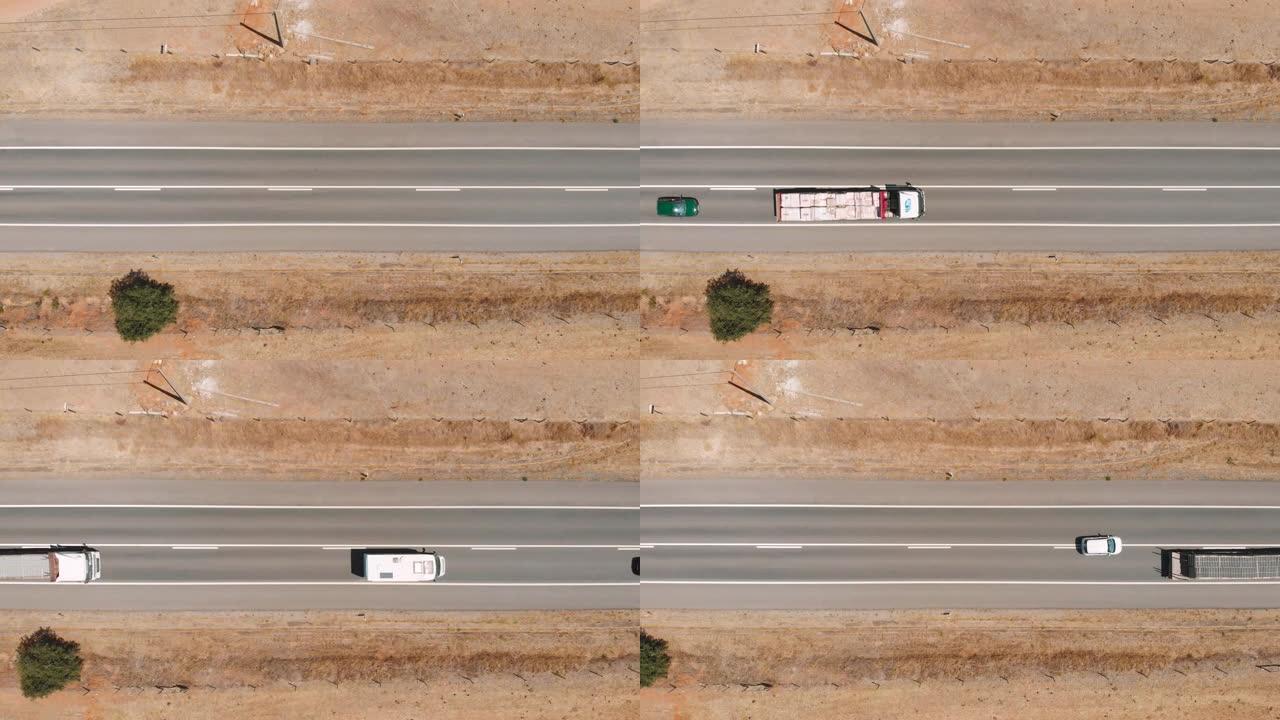 用卡车在沙漠公路上空飞行的俯视图