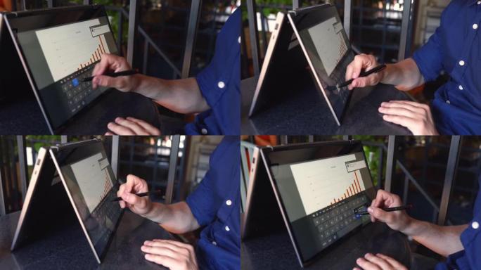 商人在帐篷模式下使用带触摸屏的可转换笔记本电脑进行演示。自由职业者与带触摸显示器的二合一变压器笔记本