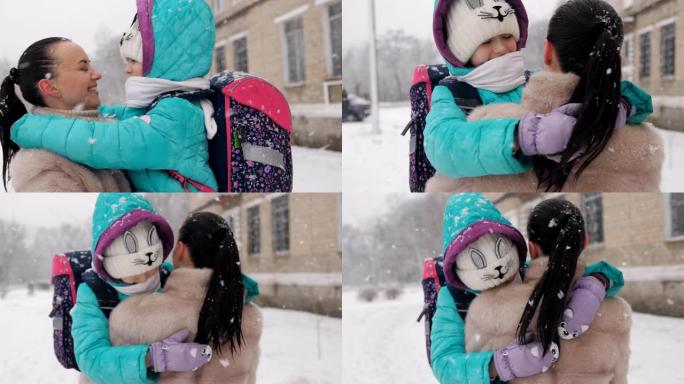 冬天穿皮大衣的女人抱着我的女儿背着背包，把她抱在怀里放学回家。