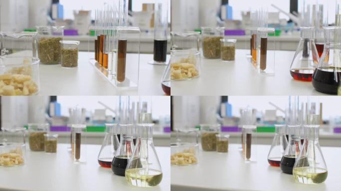实验室桌上玻璃中的CBD油，大麻籽和萜烯