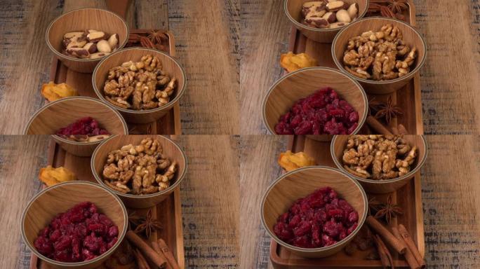 木质背景上的木碗混合坚果和干果，复制空间