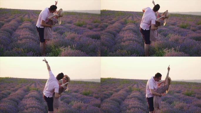 一对年轻的情侣在盛开的薰衣草地里亲吻，慢镜头