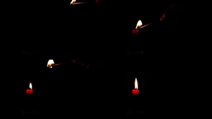 在黑暗中被一根火柴点燃的老式银烛台上的红色蜡烛