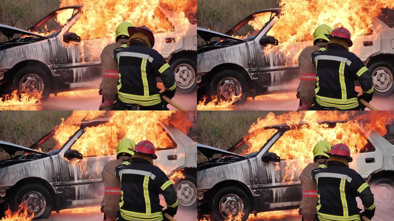 亚洲消防员穿防火服的后视图。消防人员在消防站概念的消防演习交通事故中与汽车起火。慢动作