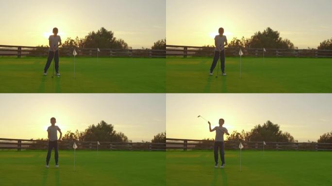 日落时打高尔夫球的男孩