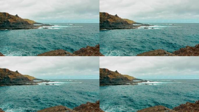 岩石海岸和碧绿的海水。海洋岛的风景。西班牙特内里费加拉奇科