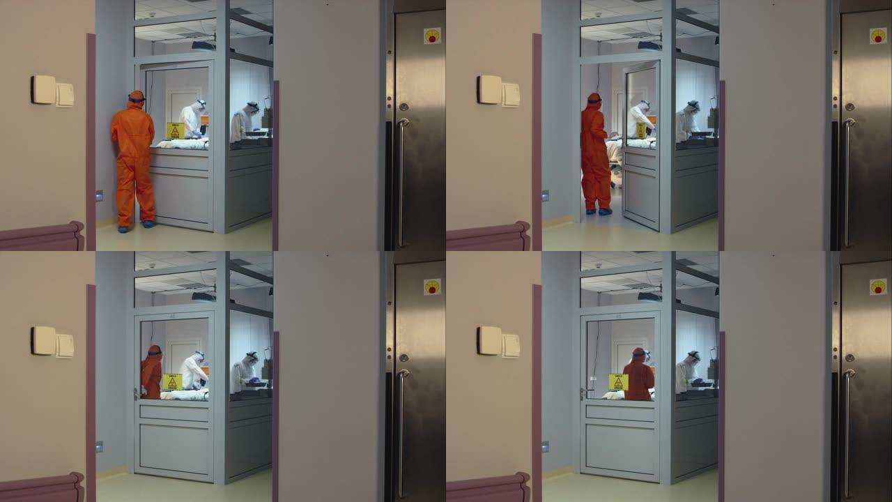 穿着橙色防护服的医生带着冠状病毒病人进入隔离房间