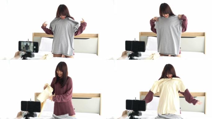 亚洲女性博客作者在相机上展示衣服，以在她的商店录制vlog视频直播
