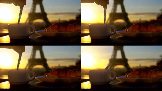 勺子在埃菲尔铁塔旁边的咖啡中搅拌糖