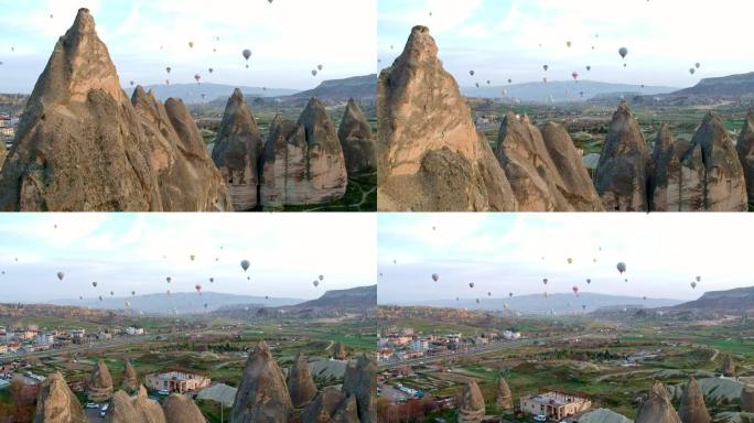 彩色热气球飞越卡帕多细亚山谷和砂岩的真菌形式的鸟瞰图，土耳其卡帕多细亚火山山上的无人机镜头