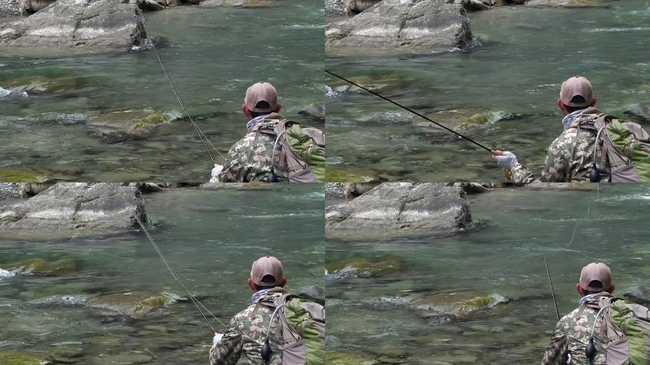 在山河中猎捕鳟鱼甩杆水边度假